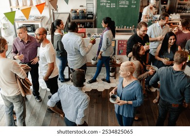 Diverse group of people socializing in cafe. Diverse people chat, enjoy drinks. Lively cafe with diverse people friends socialize. Social gathering event at lively cafe with diverse people friends - Powered by Shutterstock