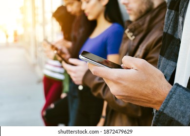 Diverse group of people using their cell phones - Concept - Modern Communication - Addiction - Shutterstock ID 1872479629