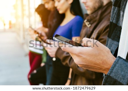 Diverse group of people using their cell phones - Concept - Modern Communication - Addiction