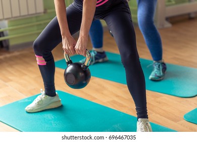 Diverse group of people working out training with kettlebells in industrial gym - Powered by Shutterstock