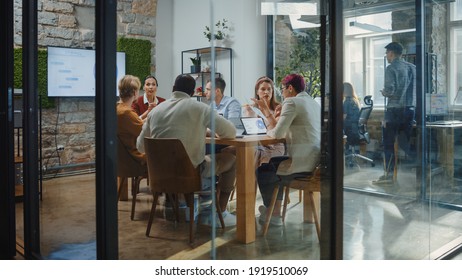 Diverse Group Of Professional Businesspeople Meeting In The Modern Office Conference Room. Creative Team Discuss App Design, Analyze Data, Plan Marketing Strategy, Disrupt Social Media, Growth Hack