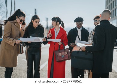 A diverse group of professionals collaborates while reviewing documents together outdoors in urban surroundings.