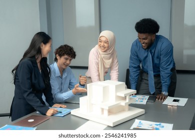 Diverse group of professionals collaborating around an architectural model in an office, showcasing teamwork, creativity, and design planning. - Powered by Shutterstock