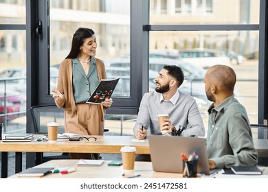 A diverse group of professionals engage in lively discussion around a table in an office setting. - Powered by Shutterstock