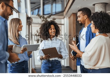 A diverse group of professionals engaged in a collaborative discussion in an office setting, highlighting teamwork and communication. The atmosphere is positive and friendly, encouraging cooperation