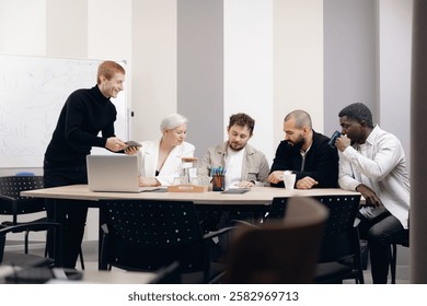 Diverse group of professionals engaged in interactive business strategy meeting. participants include african american, asian, and caucasian individuals discussing ideas around conference table.