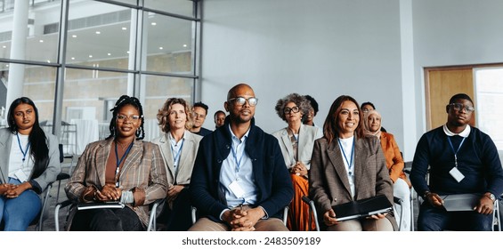 Diverse group of professionals engaged in a work conference, showcasing teamwork and collaboration in a modern office environment. - Powered by Shutterstock