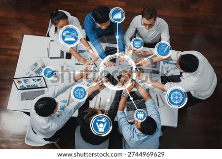 A diverse group of professionals engages in a collaborative meeting in a modern office. Technology and data visualizations support brainstorming and strategic planning. Amity