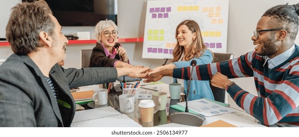 Diverse group of professionals engaging in a creative brainstorming session. Workplace inclusivity, teamwork, and innovation in a modern office setting with dynamic interaction. - Powered by Shutterstock