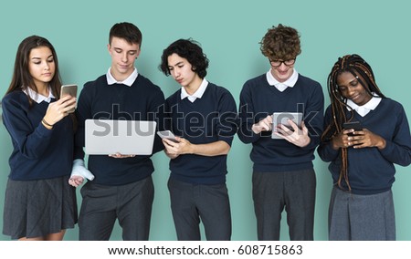 Diverse Group Of Students Using Electronic Devices