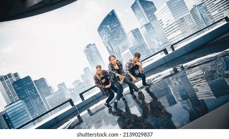 Diverse Group Of Three Young Professional Dancers Performing A Hip Hop Dance Routine In Close Up In Front Of A Big Led Screen With Modern Urban Skyline With Office Skyscrapers In Studio Environment.