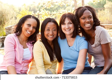 Diverse group of women talking and laughing. - Shutterstock ID 713375815