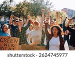Diverse group of young activists protesting, holding signs and raising fists, demanding climate action and a green new deal