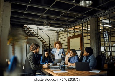 Diverse group of young designers working on project in office - Powered by Shutterstock