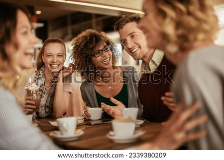 Diverse group of young people talking and having a coffee at a cafe [[stock_photo]] © 