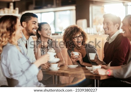 Diverse group of young people talking and having a coffee at a cafe Foto stock © 