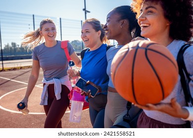 Diverse group of young woman walking on basketball court preparing to play. - Powered by Shutterstock