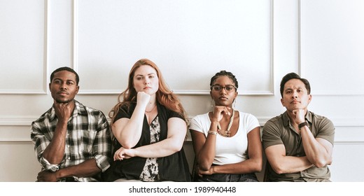 Diverse Grumpy People Sitting By A White Wall