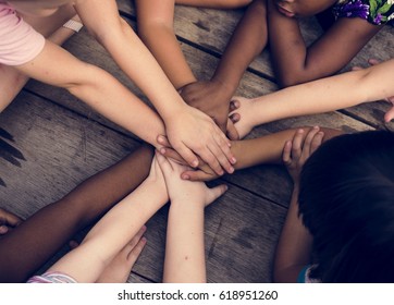 Diverse Hands Are Join Together On The Wooden Table