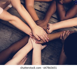 Diverse Hands Are Join Together On The Wooden Table