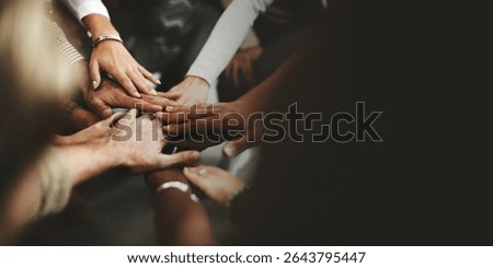 Diverse hands together in unity. Multiracial group showing teamwork. Hands in cooperation, symbolizing diversity and inclusion. Unity and diversity in teamwork. Professional business image.