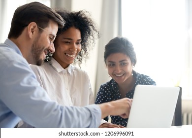 Diverse happy interns learning new computer software listening to mentor teacher coach teaching explaining online project application on laptop, smiling multi-ethnic coworkers work together in office - Shutterstock ID 1206996091