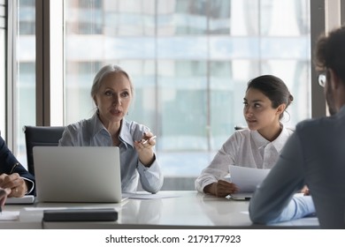 Diverse HR Team And Senior Female Boss Holding Job Interview, Talking To Candidate At Meeting Table. Mentor Training Multiethnic Group Of Interns, Instructing New Employees