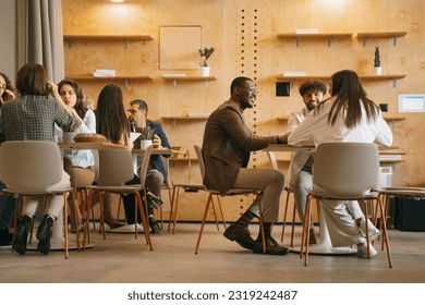 Diverse, inter-generational group of creative people working on a new project at modern co working space - Powered by Shutterstock