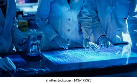 Diverse International Team Of Scientists Are Working On A Digital Touch Screen In High Tech Research Laboratory. Professionals Teamwork.