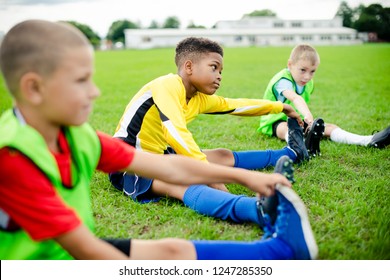 Diverse kids stretching on the field