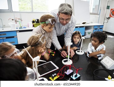 Diverse Kindergarten Students Learning Energy Producer From Solar Windmill In Science Class