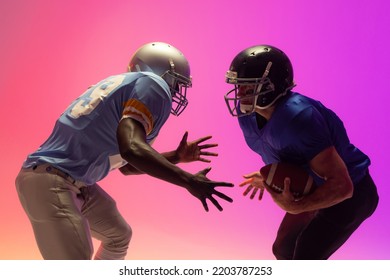 Diverse male american football players holding ball with neon pink lighting. Sport, movement, training and active lifestyle concept. - Powered by Shutterstock