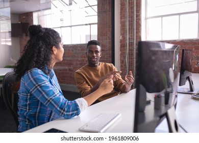 Diverse Male And Female Colleagues At Work Sitting In Front Of Computer Discussing. Independent Creative Design Business.