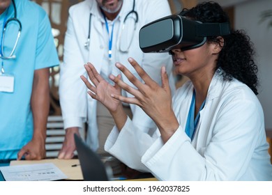 Diverse Male And Female Doctors Wearing Face Masks Sitting At Table And Using Vr Glasses. Medicine, Health And Healthcare Services.