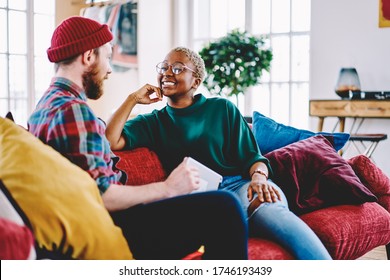 Diverse Male And Female Hipsters Having Positive Conversation Enjoying Together Resting During Weekend At Home Interior, Cheerful Couple In Love Talking About Relationships At Own Designed Apartment