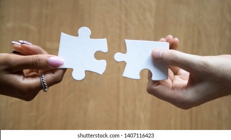 Diverse Man And Woman Hands Holding Joining Pieces Connecting Jigsaw Puzzle Finding Best Match In Couple Relationships Concept, Help In Business Solutions, Teamwork Love Connection, Close Up Top View