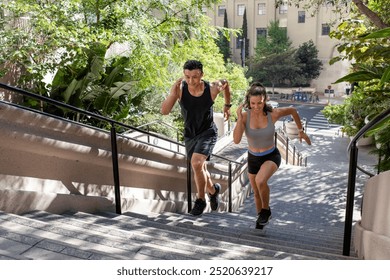 Diverse man and woman running up the steep stairs. Outdoor sport exercising. Health and wellness concept. Couple running and exercising outdoor. Healthy lifestyle concept. Sports and fitness concept. - Powered by Shutterstock