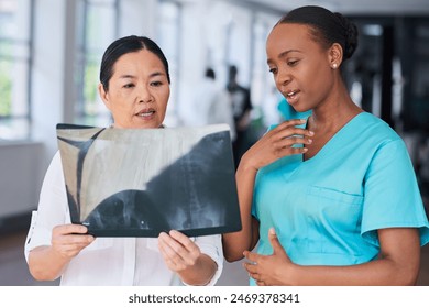 Diverse Medical Team Analyzing X-ray in a Hospital Setting - Powered by Shutterstock