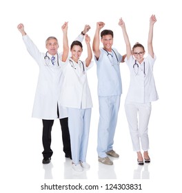 Diverse Medical Team Of Male And Female Doctors And Nurses Celebrating A Successful Outcome To A Case