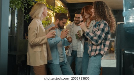 Diverse men women freelancers coworkers dancers friends happy joyful girls guys male female dance music business team office colleagues dancing in bar coworking celebrate corporate party coffee break - Powered by Shutterstock