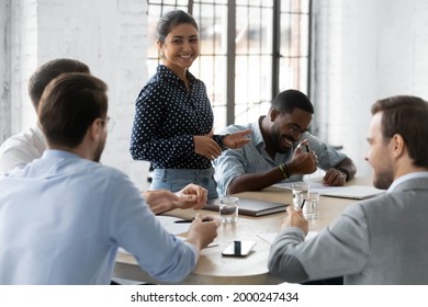 Diverse Millennial Business Team With Indian Leader Discussing Project, Brainstorming In Office, Talking, Laughing. Corporate Teacher Training Staff, Mentoring Employees, Holding Meeting Or Training