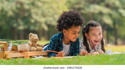 Diverse Mixed Race Kids Boy And Girl As Friends Having Fun Playing Together During Picnic In Park In Summer