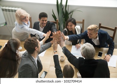 Diverse Motivated Multi-ethnic Business Team Giving High Five Showing Unity Concept, Young And Old Corporate Group Join Hands Promising Support In Collaboration, Help Commitment In Teamwork, Top View