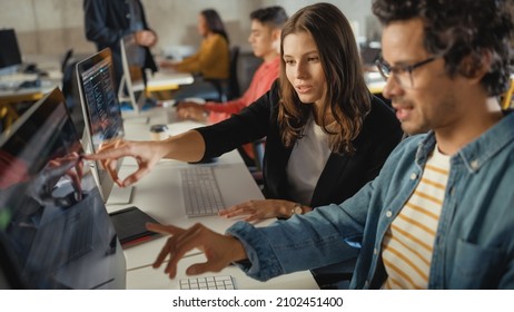 Diverse Multiethnic Group of Female and Male Students Sitting in College Room, Collaborating on School Projects on a Computer. Young Scholars Study, Talk, Apply Academic Skills and Knowledge in Class.