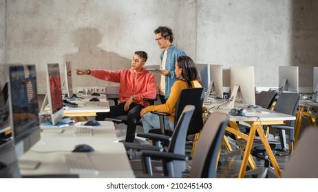 Diverse Multiethnic Group Of Female And Male Students Sitting Together In Infographics Room, Collaborating On A College Project. Young Scholars Talking, Study Software Development Or Computer Science.