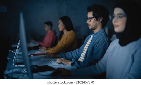 Diverse Multiethnic Group Of Female And Male Students Sitting In College Room, Learning Computer Science. Young Scholars Study Information Technology On Computers In University, Writing Code In Class.