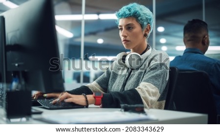 In Diverse Multi-Ethnic Office: Portrait of Young Stylish Woman Working on Desktop Computer. Non-Binary Person Creating Modern Content, Do Contemporary Project Design, Create Colorful Marketing