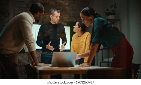 Diverse Multiethnic Team are Having a Conversation in a Meeting Room Behind Glass Walls in a Creative Office. Colleagues Lean On a Conference Table and Discuss Business, App User Interface and Design. - Shutterstock ID 1903260787