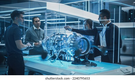 Diverse Multiethnic Team of Industrial Engineers Gathered Around a Table With a Prototype Turbine Engine. Scientists Use Tablet Computer to Research, Develop and Program the Futuristic Motor. - Powered by Shutterstock