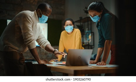 Diverse Multiethnic Team Wearing Face Masks During a Meeting Room Conversation Behind Glass Walls in Creative Office. Social Distancing Restrictions Concept in Work Place During Coronavirus Pandemic. - Powered by Shutterstock